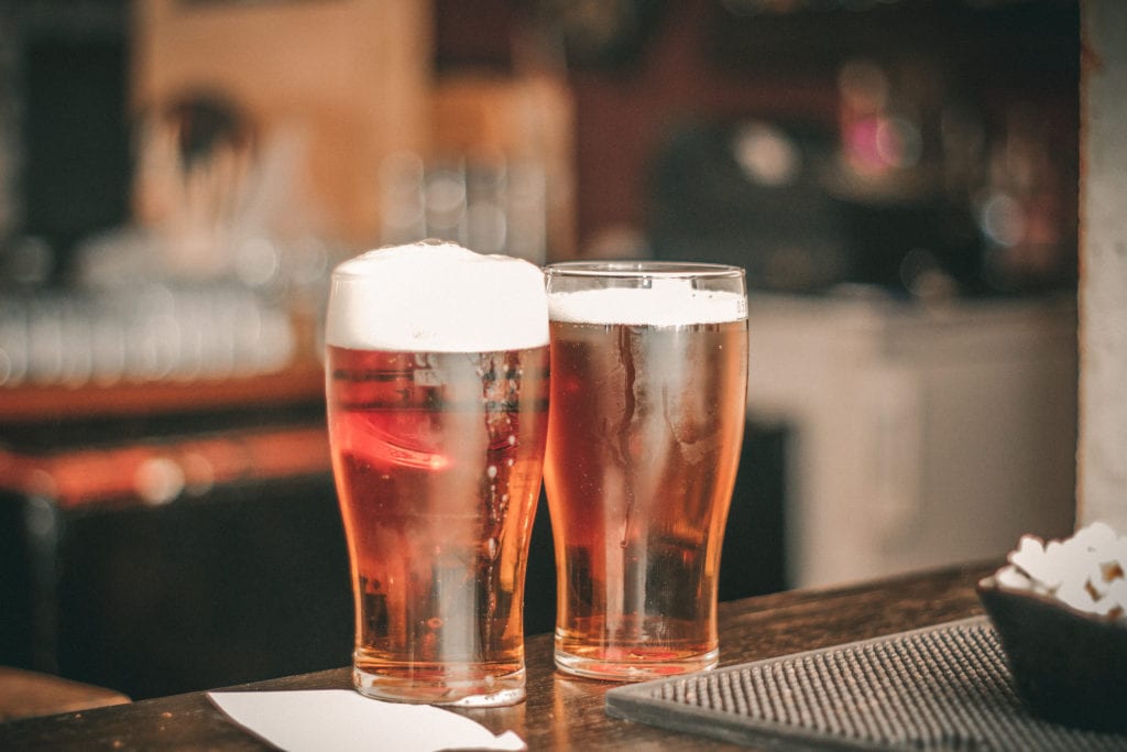 a picture of two pint glasses filled with beer.