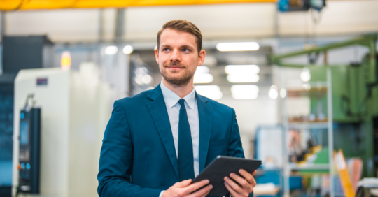 business man with tablet in manufacturing